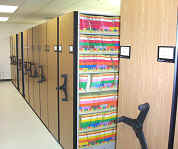 manual_high_density_shelving_systems_with_color_coded_filing_on_the_shelving